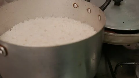 Close-up: Intense steam rising from a rice pot. A rice pan on the stove Stock Footage 332085846
