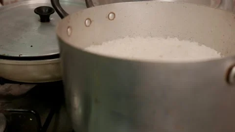 Close-up of intense steam rising from a rice pot. A hot rice pan on the stove Stock Footage 337926962