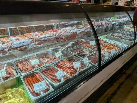 Close interior of small-town meat store with sausages 库存照片