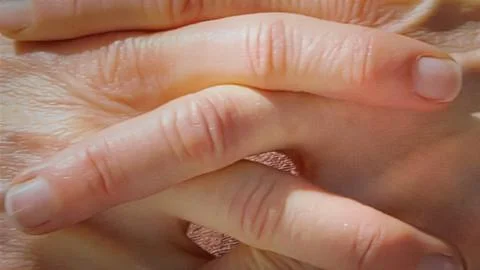 Close up of interlaced fingers in frontal view Stock Photos