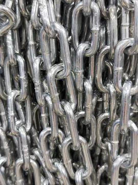Close-up of interlinked metal chains with shiny steel texture Stock Photos