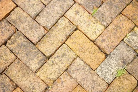 Close-up of an interlocking brick pavement with a herringbone pattern and ... Stock Photos