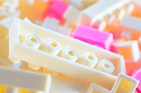 Close-up of interlocking plastic building blocks in pastel colors, creating.. Stock Photos