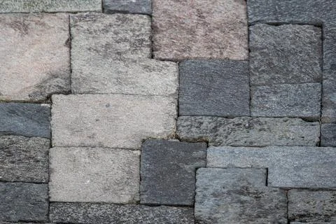 Close-up of interlocking stone blocks with various shades and textures. Stock Photos