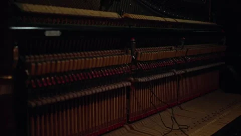 Close-up of the internal action of an upright piano, showing hammers, dampers Vidéo 332791342