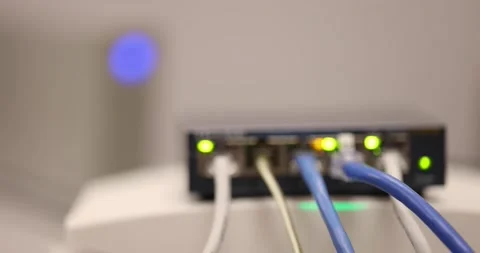 Close-up internet network switch plugged ethernet cables connected to simple hom Stock Footage 177373842