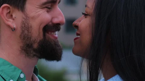 A close-up of an interracial couple sharing an intimate moment Stock Footage 315874994