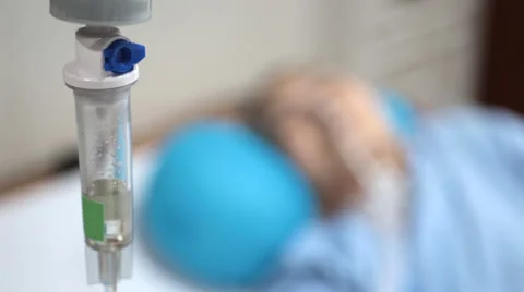 Close up of intravenous drip , face out of focus in vip room at hospital . Stock Footage 47213706