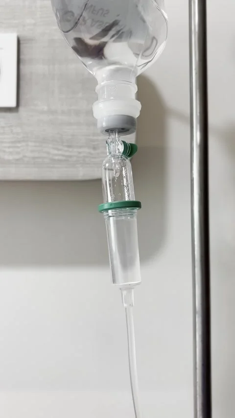 Close Up of Intravenous IV Drip Chamber with Falling Drops Vertical Video Stock Footage 339327042