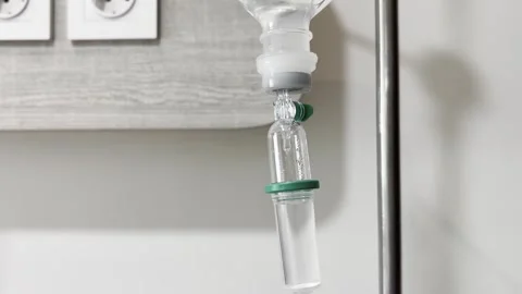 Close Up of Intravenous IV Drip Chamber with Falling Fluid Drops Stock Footage 339327111