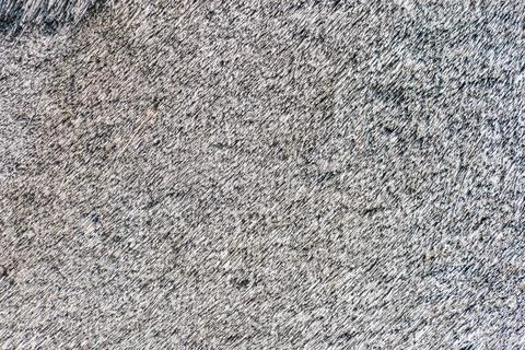 Close-up of an intricate, granular pattern resembling sand in an ancient Ce.. 库存照片
