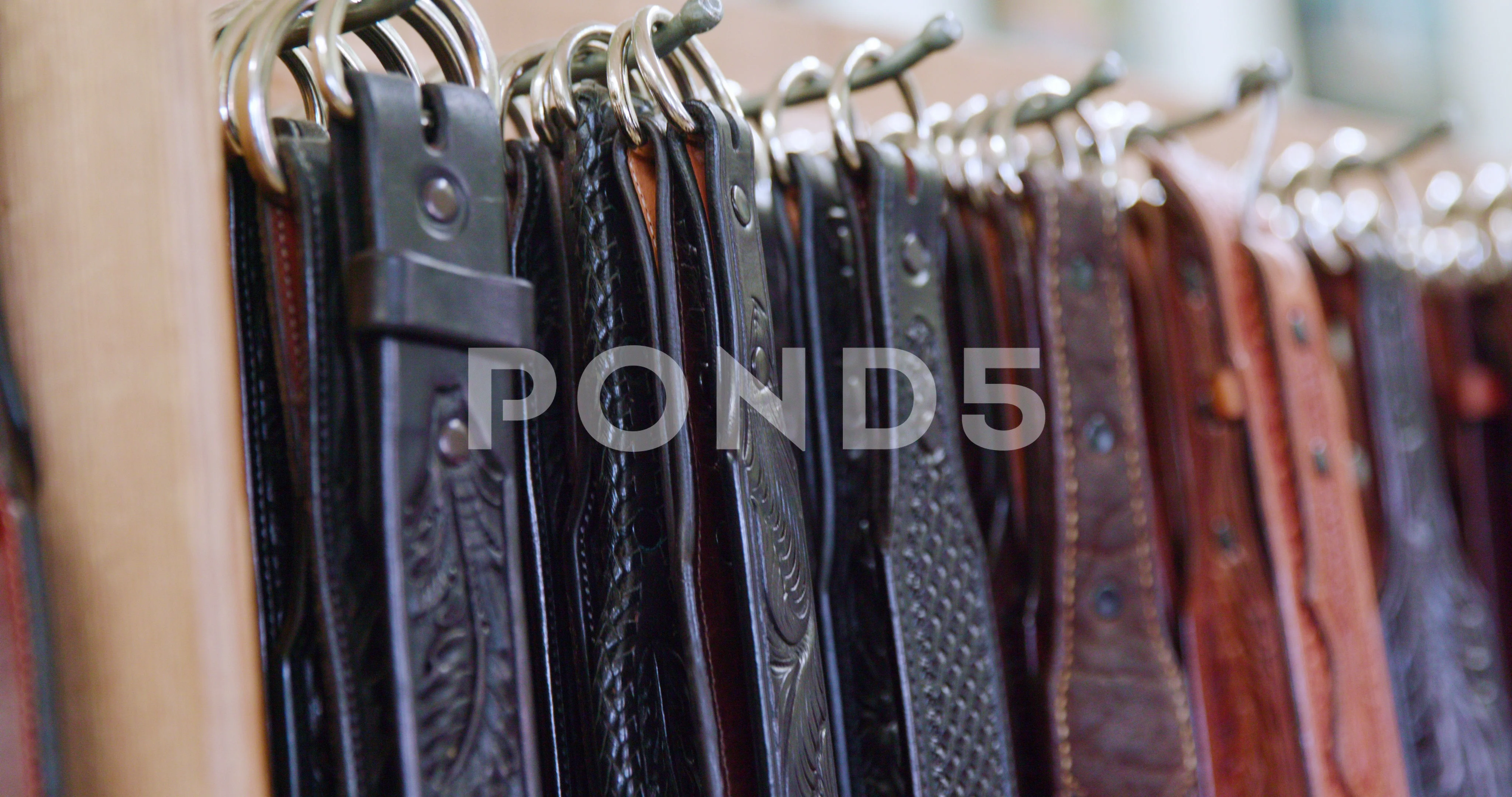 High quality fake designer belts hanging, Stock Video