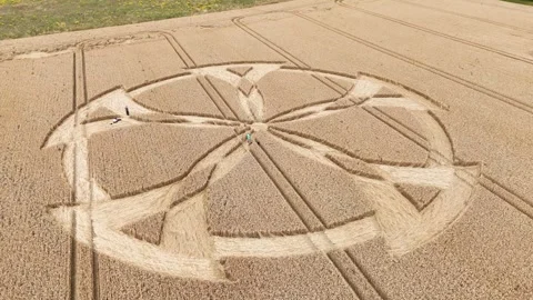 Close up on intricate mandala shaped crop circle of unknown origin, aerial Stock Footage 283623984