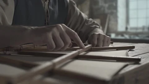 Close up of inventor hands checking the smoothness of a glider wing frame Stock Footage 340079744