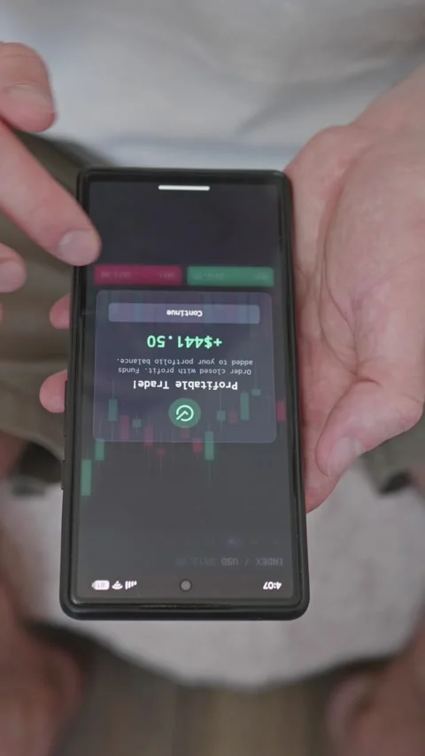 Close up investor executing profitable stock market trade on mobile app screen Stock Footage 341860728