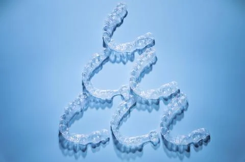 Close up, invisible aligners on a blue background in the shape of a pyramid or 스톡 사진