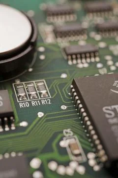 Close-ip of green computer circuit board with hard disc, memory chip, silver 스톡 사진
