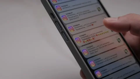 Close up of iPhone screen with Male Hand scrolling Instagram Notification Video stock 209263995