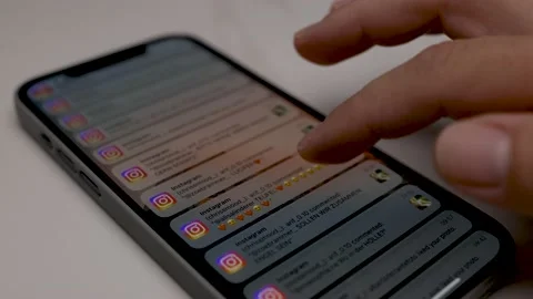 Close up of iPhone screen with Male Hand scrolling Instagram Notification Stock Footage 209264352