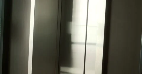 Close-up of iron elevator doors in a business center. The doors open to reveal. Stock Footage 283542323