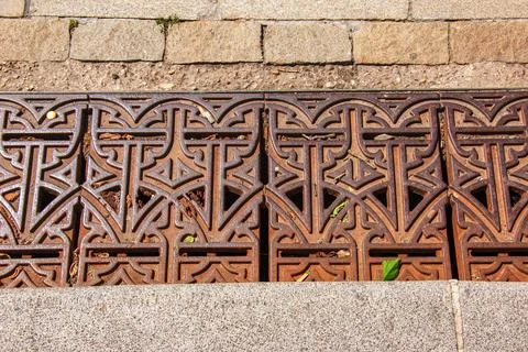 Close-up iron grate drainage system for draining rainwater in Slovakia. Stock Photos