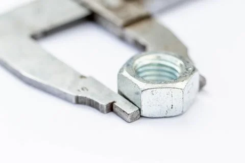 Close-up iron nut on white background with a wrench Stock Photos