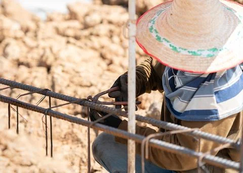 Close-up of an ironworker wearing protective gloves tying steel reinforceme.. 스톡 사진