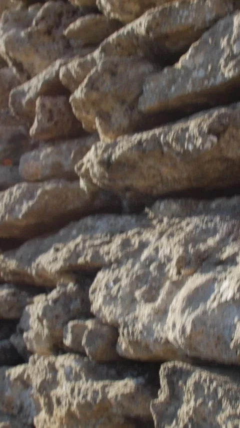 Close-up of irregular dry stone wall showing weathered rocks Video stock 330584878