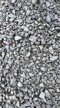 Close up of irregular gray and beige gravel stones scattered across a compact Stock Photos