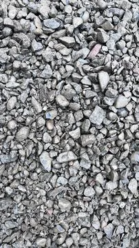 Close up of irregular gray and light brown gravel stones scattered across the Stock Photos