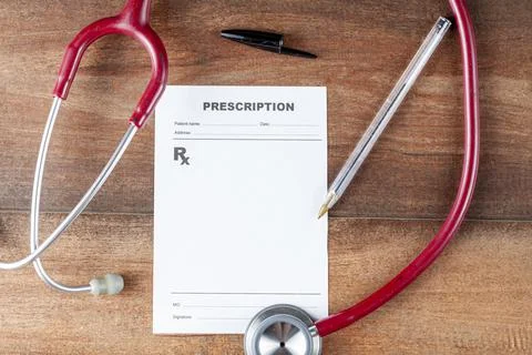 Close up isolated flat lay image of a physician's desk with blank prescription Stock Photos