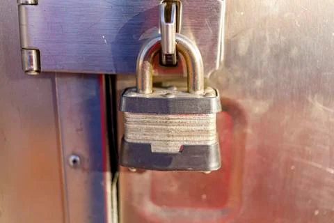 Close up isolated image of a cast iron rough textured heavy duty padlock Stock Photos