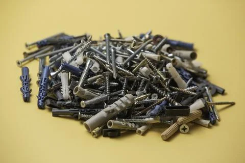 Close up isolated image of sets of gray plastic dowels plugs and shiny metal  Stock Photos