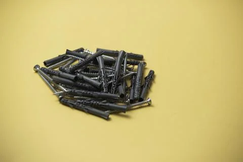 Close up isolated image of sets of gray plastic dowels plugs and shiny metal  Stock Photos