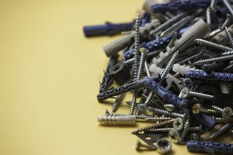 Close up isolated image of sets of gray plastic dowels plugs and shiny metal  Stock Photos