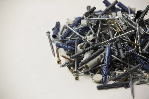 Close up isolated image of sets of grey plastic dowels plugs and shiny metal  Stock Photos