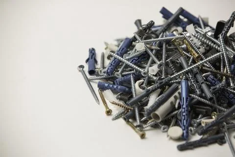 Close up isolated image of sets of grey plastic dowels plugs and shiny metal  Stock-Fotos