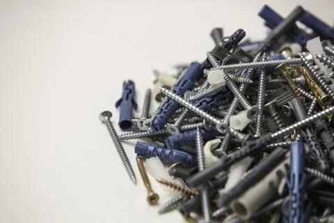 Close up isolated image of sets of grey plastic dowels plugs and shiny metal  Stock Photos