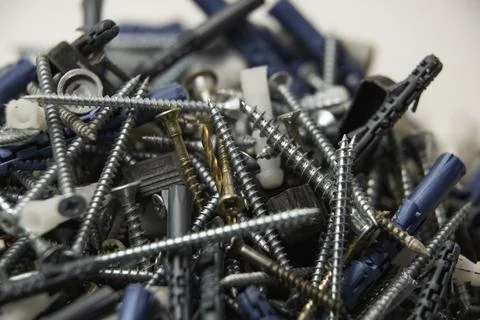 Close up isolated image of sets of grey plastic dowels plugs and shiny metal  Stock Photos
