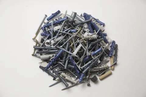 Close up isolated image of sets of grey plastic dowels plugs and shiny metal  Foto stock