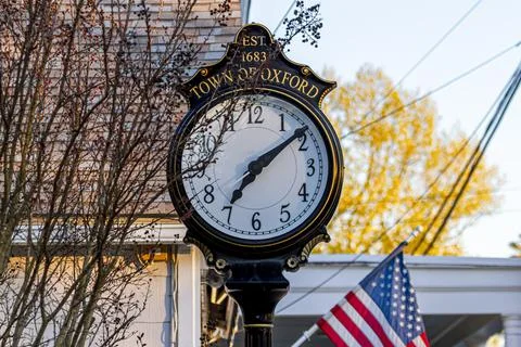 Close up isolated image of a stand alone vintage clock in the town center of  Stock Photos