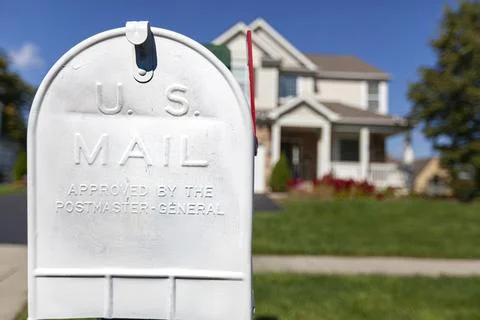 Close up isolated image of a white painted metal mail box in front of a singl Stock Photos