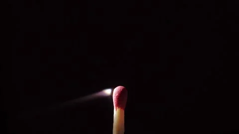 Close up of an isolated Match sitck catching fire against a black background Stock Footage 139159439