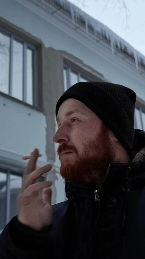 Close-up isolated portrait of man with a red beard who smokes a cigarette Stock Footage 321353254