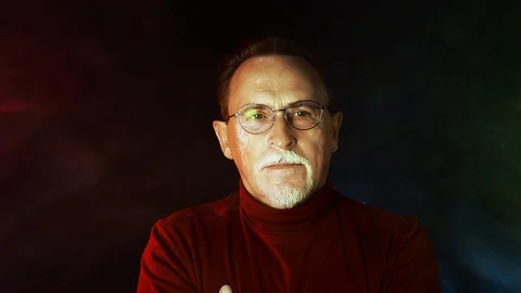 Close up isolated portrait of senior man in glasses on black background Stock Footage 129183688