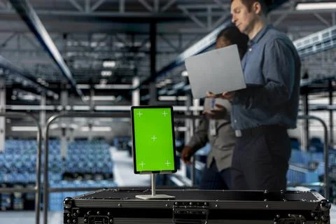 Close up of isolated screen tablet used by teamworking data center admins Stock Photos