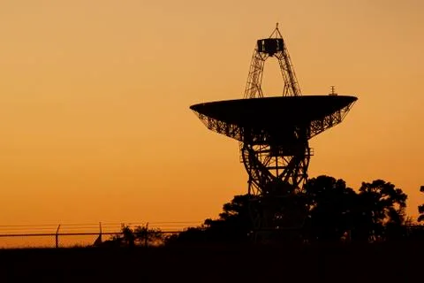 Close up isolated silhouette image of a large radio telescope antenna Stock Photos