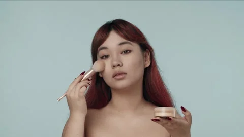 Close-up isolated slow motion video of a young seminude woman with red dyed hair Stock Footage 251739284