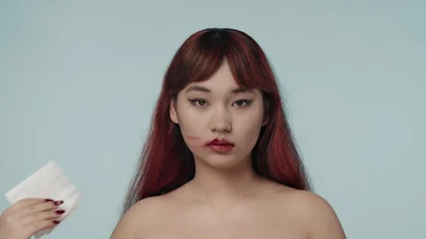 Close-up isolated slow motion video of a young seminude woman with red dyed hair Stock Footage 251741713