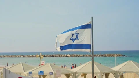 Close up on Israel flag waving in the wind by Tel Aviv beach during summer day 스톡 동영상 331877002